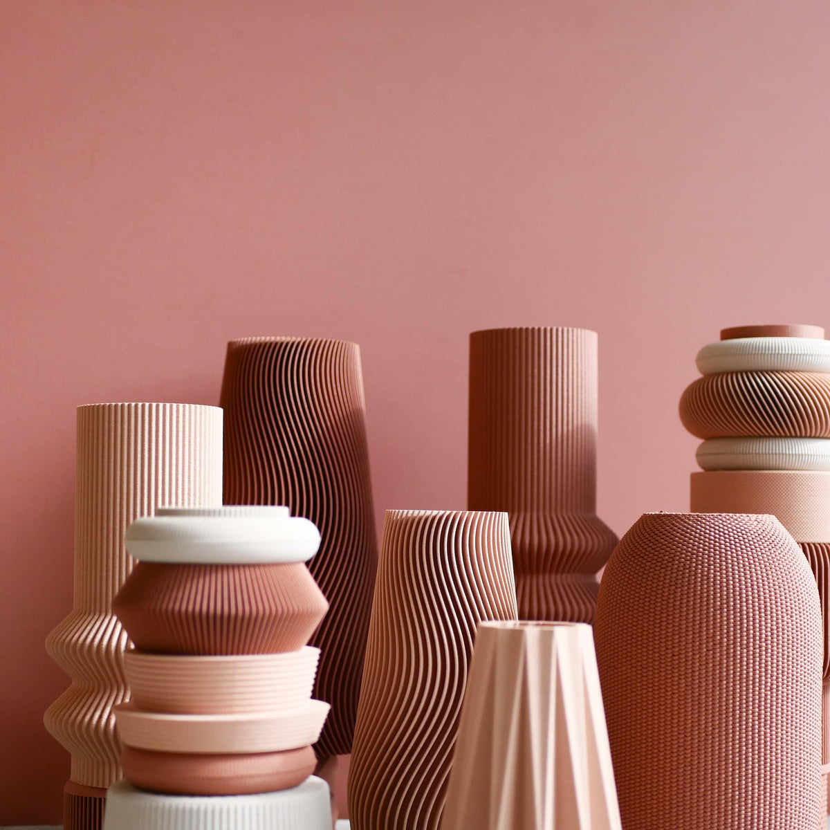Collection of pink-toned design vases by Minimum Design – modular and minimalist pieces in terracotta, blush pink and white