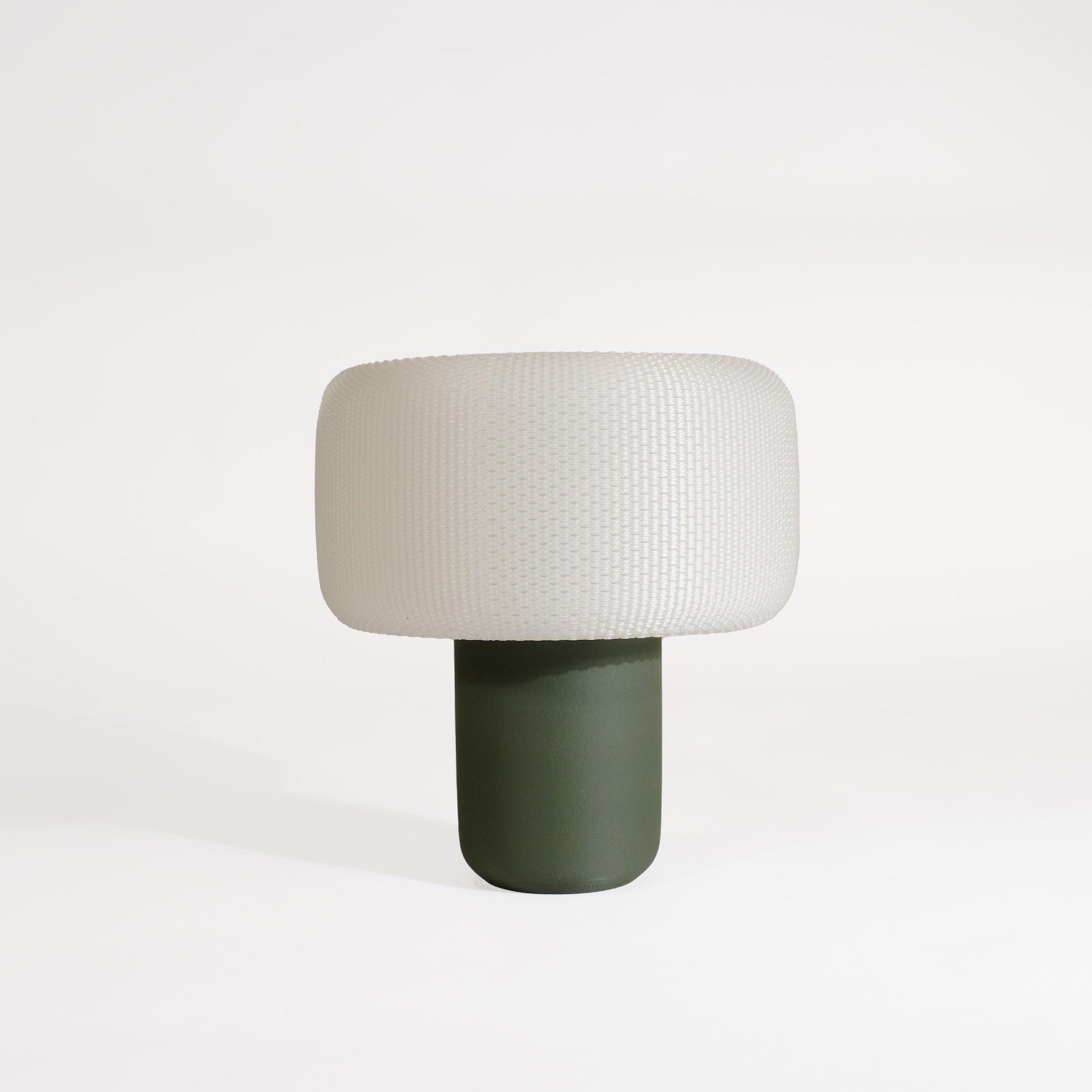 Table lamp with a textured white shade and solid wooden green base on a white background #color_green
