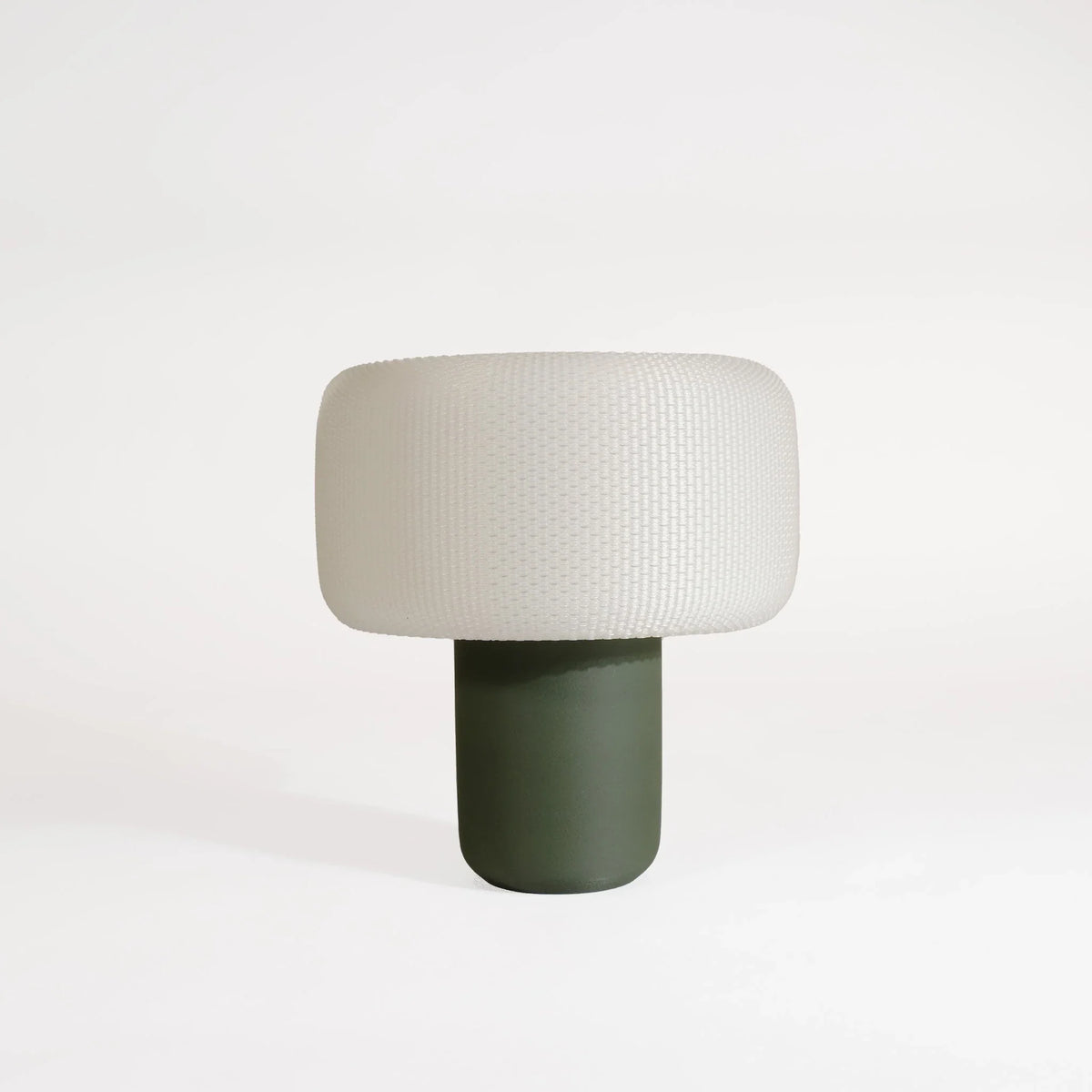 Table lamp with a textured white shade and solid wooden green base on a white background #color_green