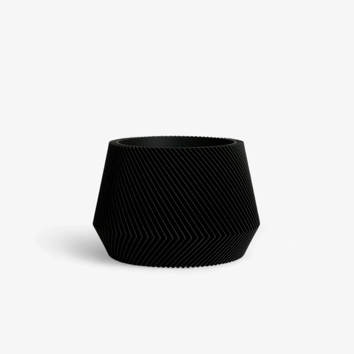 Black textured planter on a white background