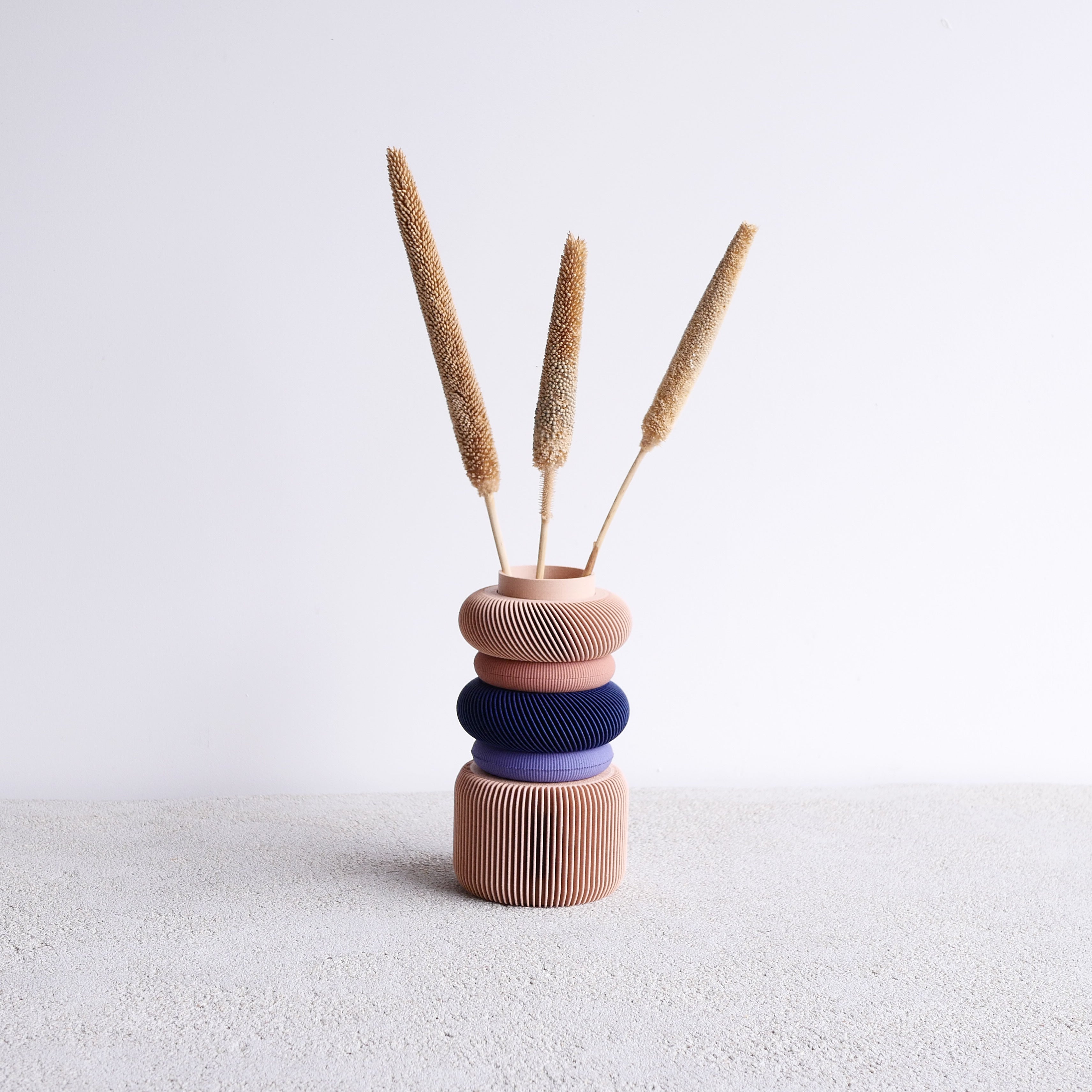 The blush Modular Vase adds a soft and elegant touch to vibrant, colorful spaces and shelves. Perfect for modern home decor, this vase combines functionality and style to enhance any room.
