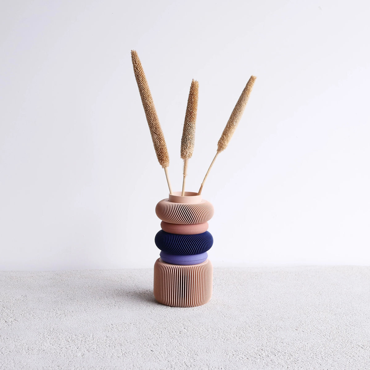 The blush Modular Vase adds a soft and elegant touch to vibrant, colorful spaces and shelves. Perfect for modern home decor, this vase combines functionality and style to enhance any room.