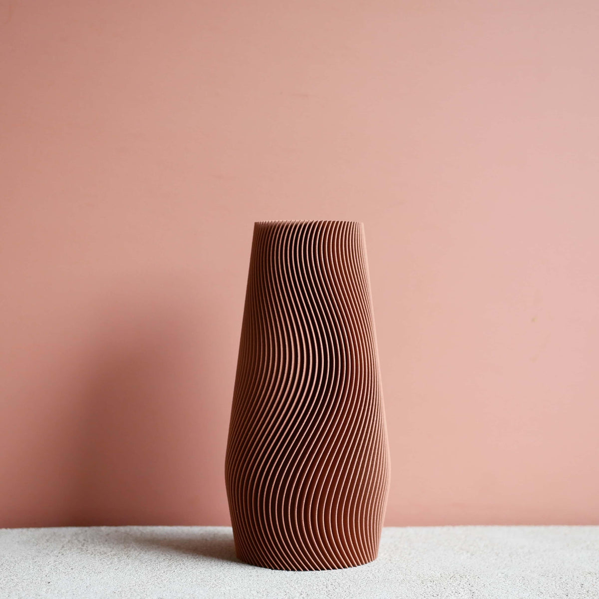Terracotta wave vase against warm wall - boho interior decoration