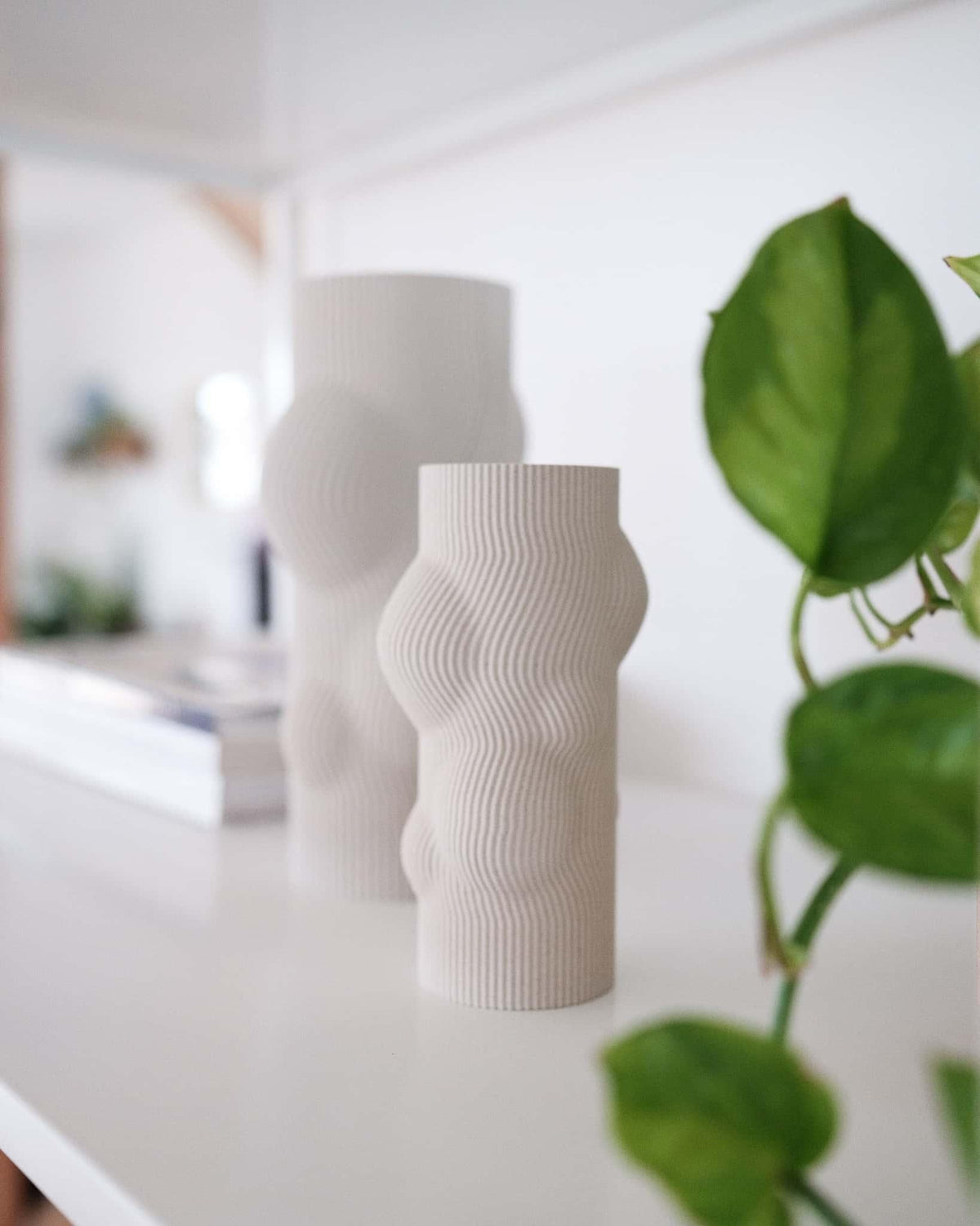 White textured vase on a table with a blurred background