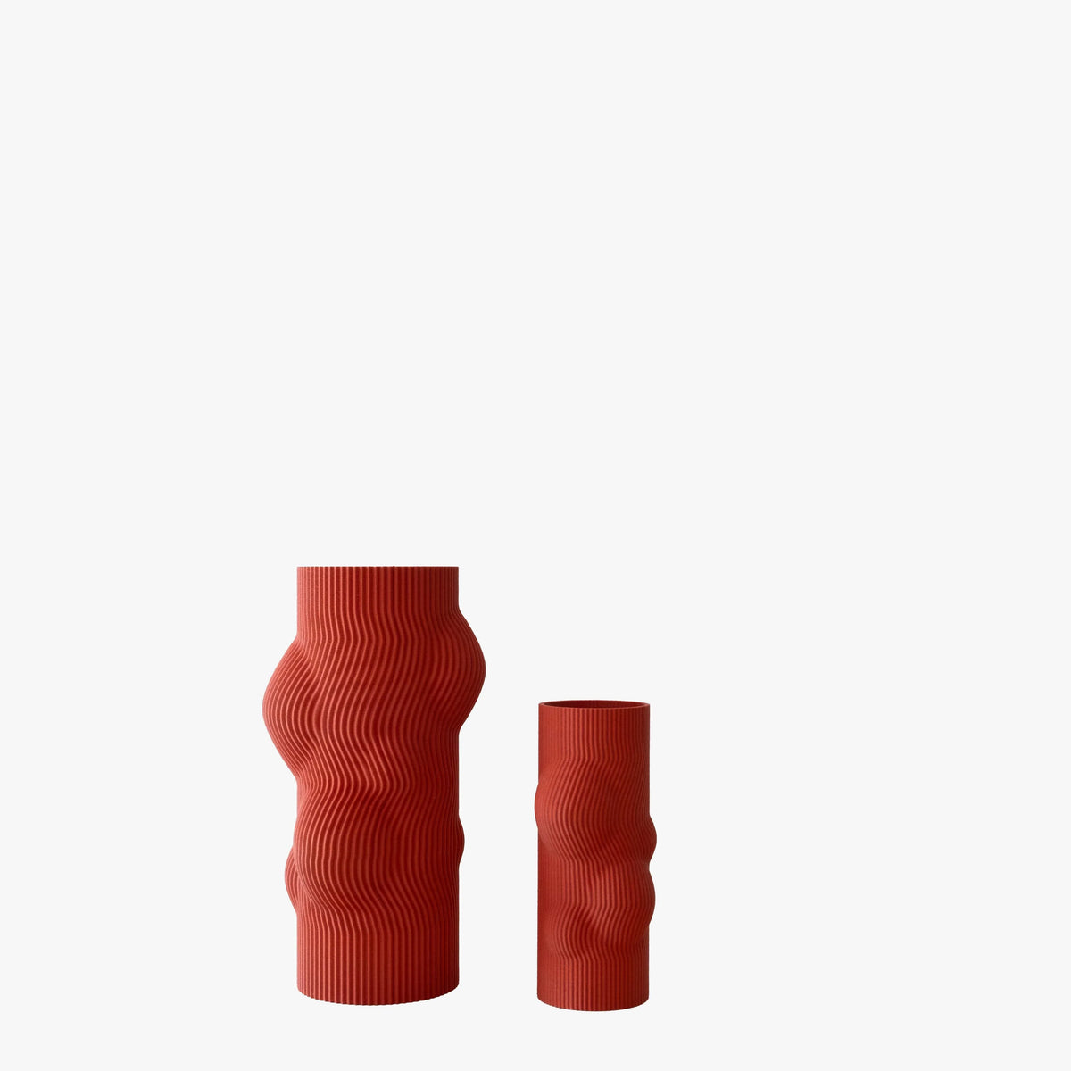 Two red textured vases on a white background