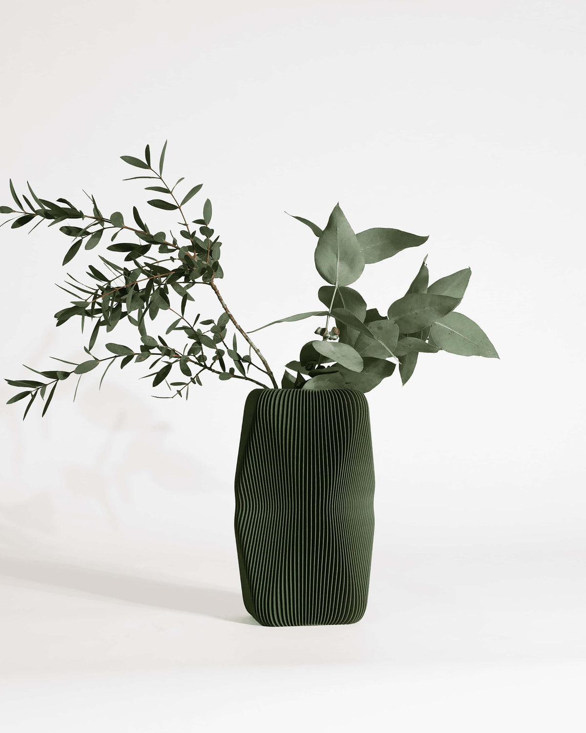 Soho sculptural vase forest green with eucalyptus and olive branches - organic sculptural vase minimalist interior
