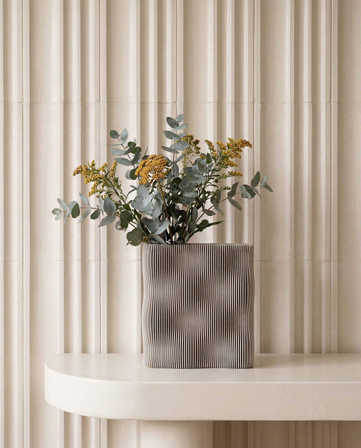 TIDE vase Mist White with eucalyptus and yellow botanicals on marble shelf, fluted wall interior styling