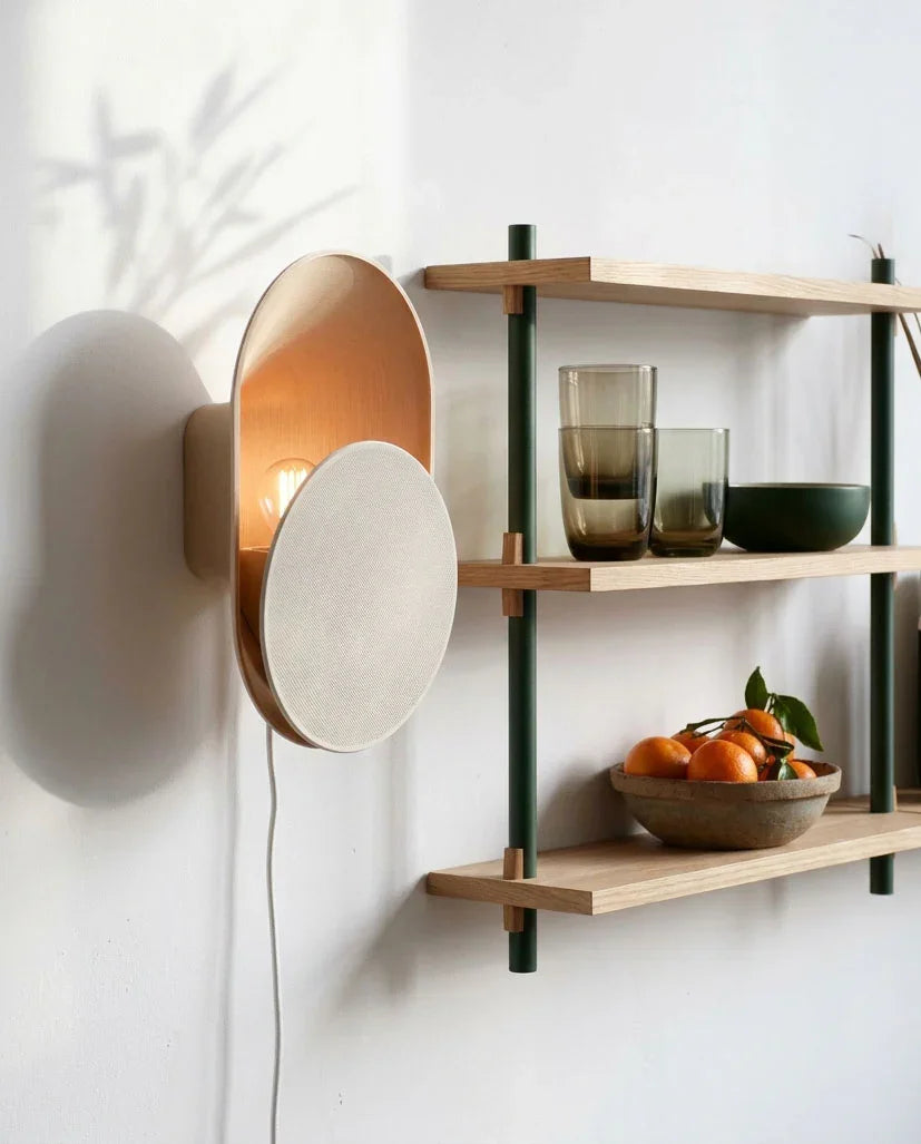 Modern wall light fixture with wooden accents on a white wall.