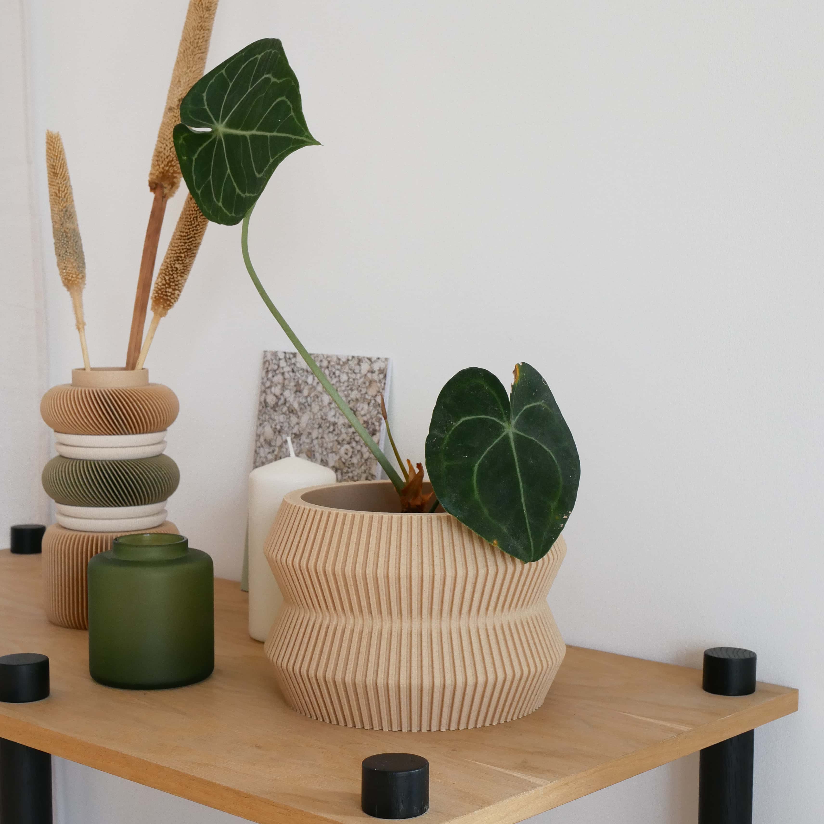 The Beige ito planter in the home decor, on a shelf and surrounded by some little home accessories. #color_Natural