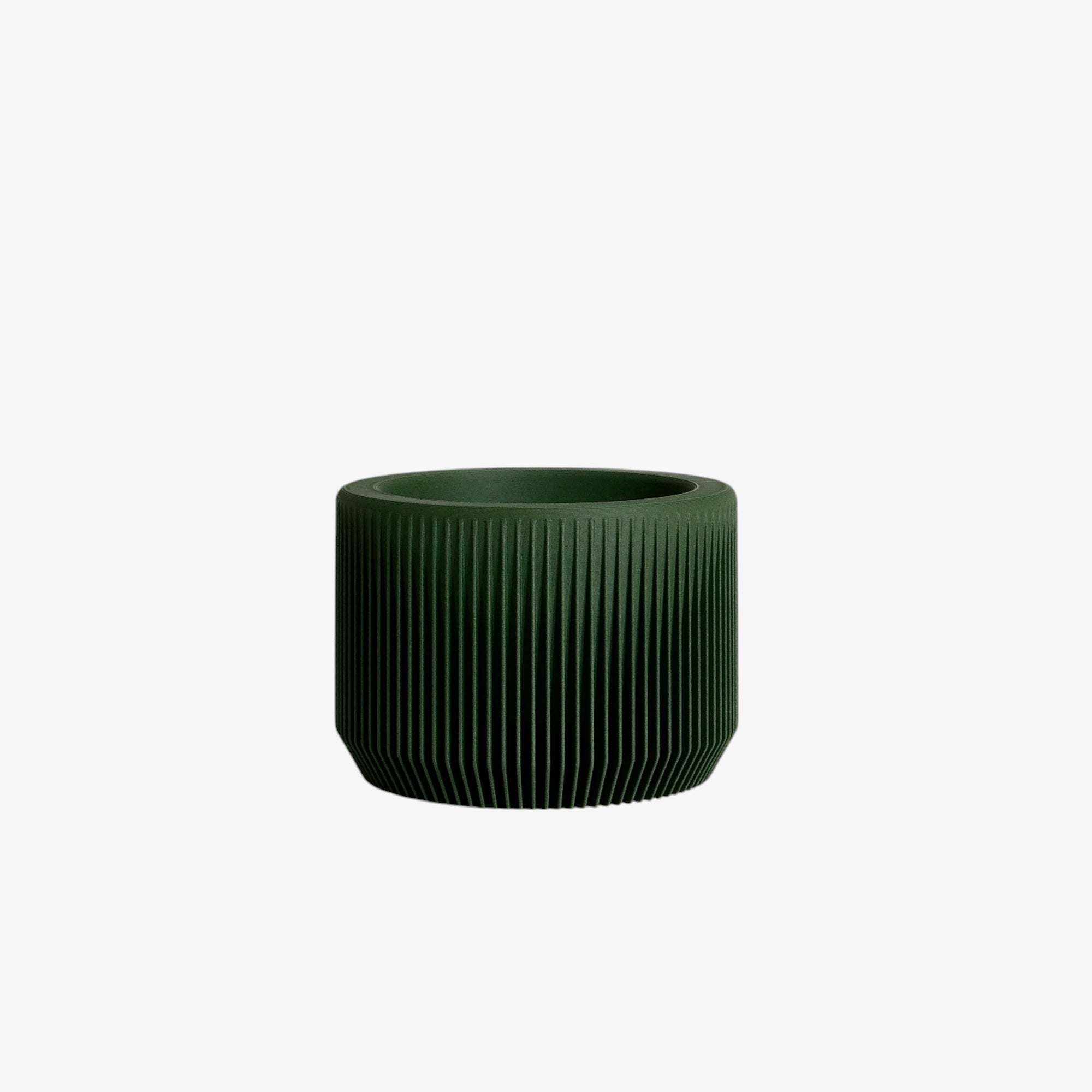 With its muted green tone, the Praha planter creates a seamless blend with indoor foliage, perfect for a cohesive, nature-inspired decor #color_Green