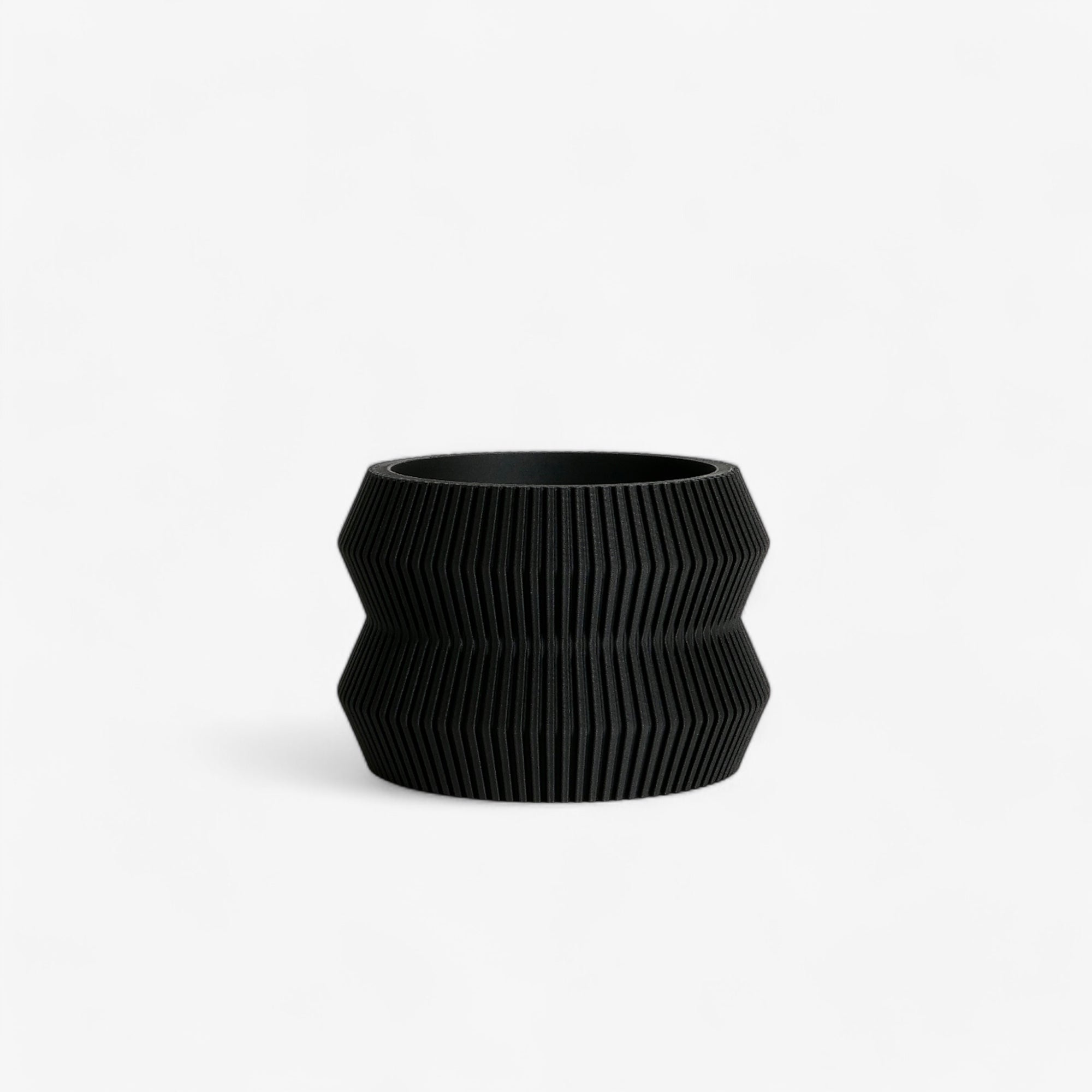 Black ITO planter with a unique textured surface, combining minimalism and elegance for a striking indoor decor. Minimum design #color_Black