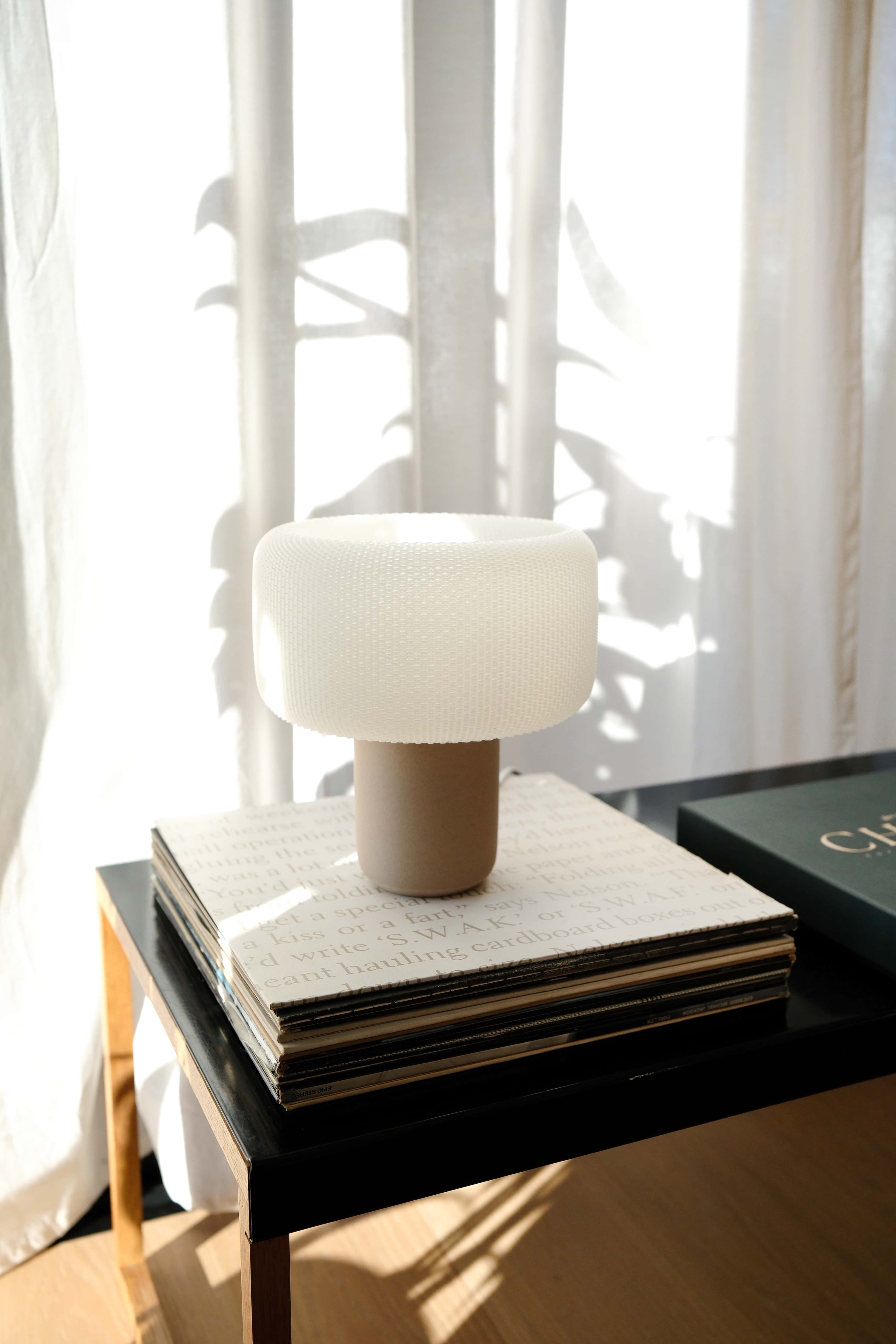 Table lamp on a stack of books with a blurred background #color_natural