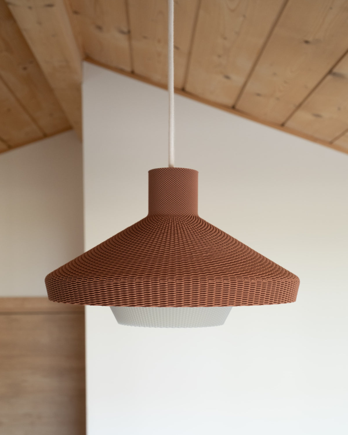 Minimum Design WOVE terracotta pendant light, double shell design, opaline white diffuser, wood ceiling