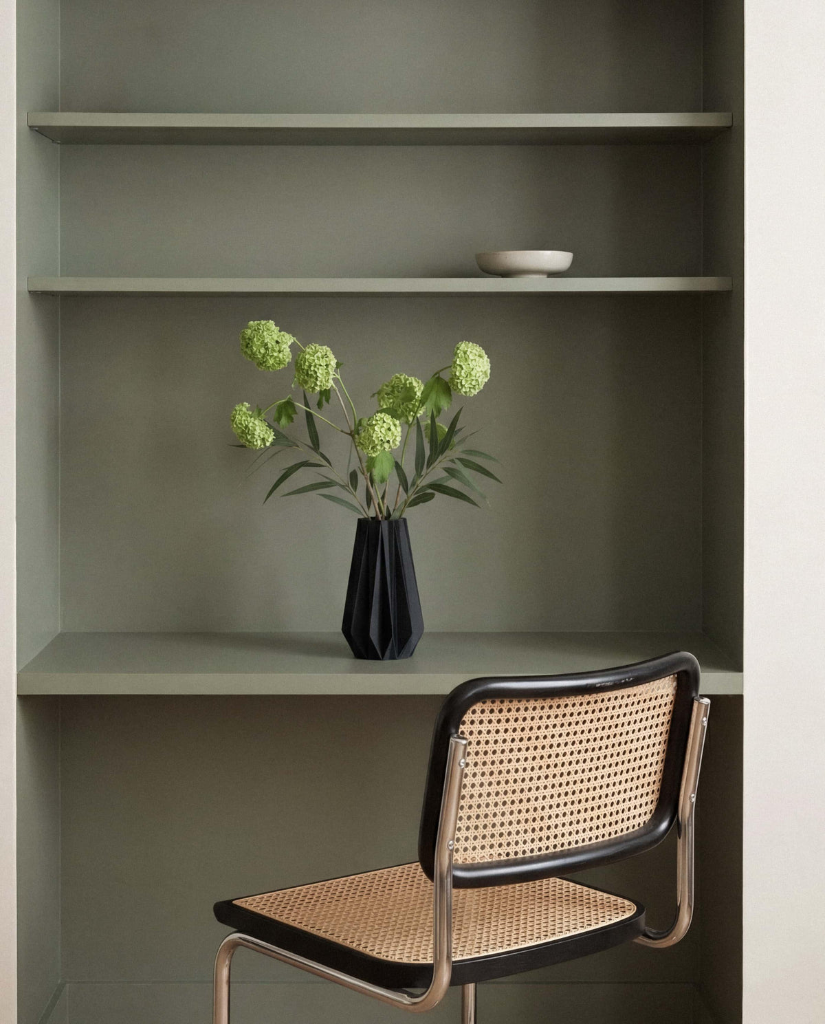 Black origami vase styled in modern interior - contemporary home decor