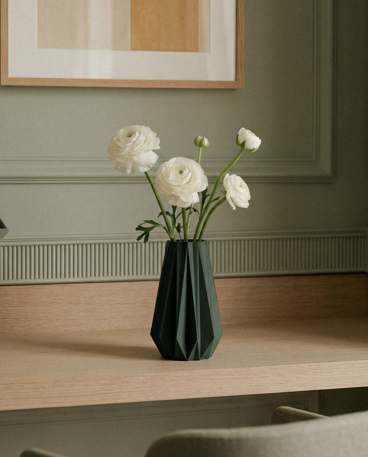 Dark green origami vase with white flowers - Japandi interior styling