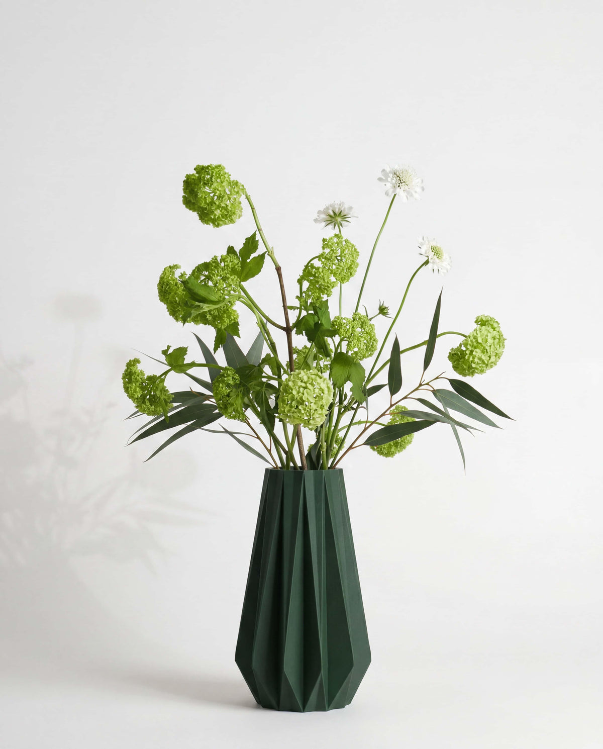 Forest green origami vase with fresh flowers - minimalist vase white background