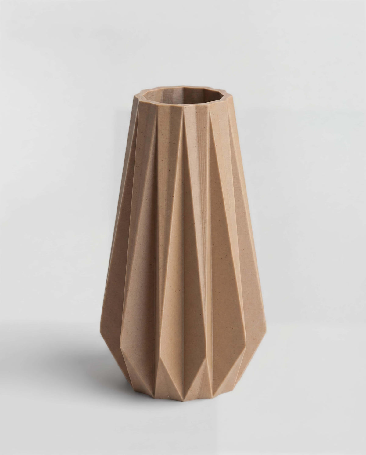 Origami vase natural wood color - geometric pleated design on white background