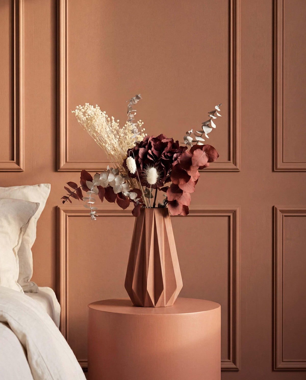 Terracotta origami vase with dried flower stems - boho interior decoration
