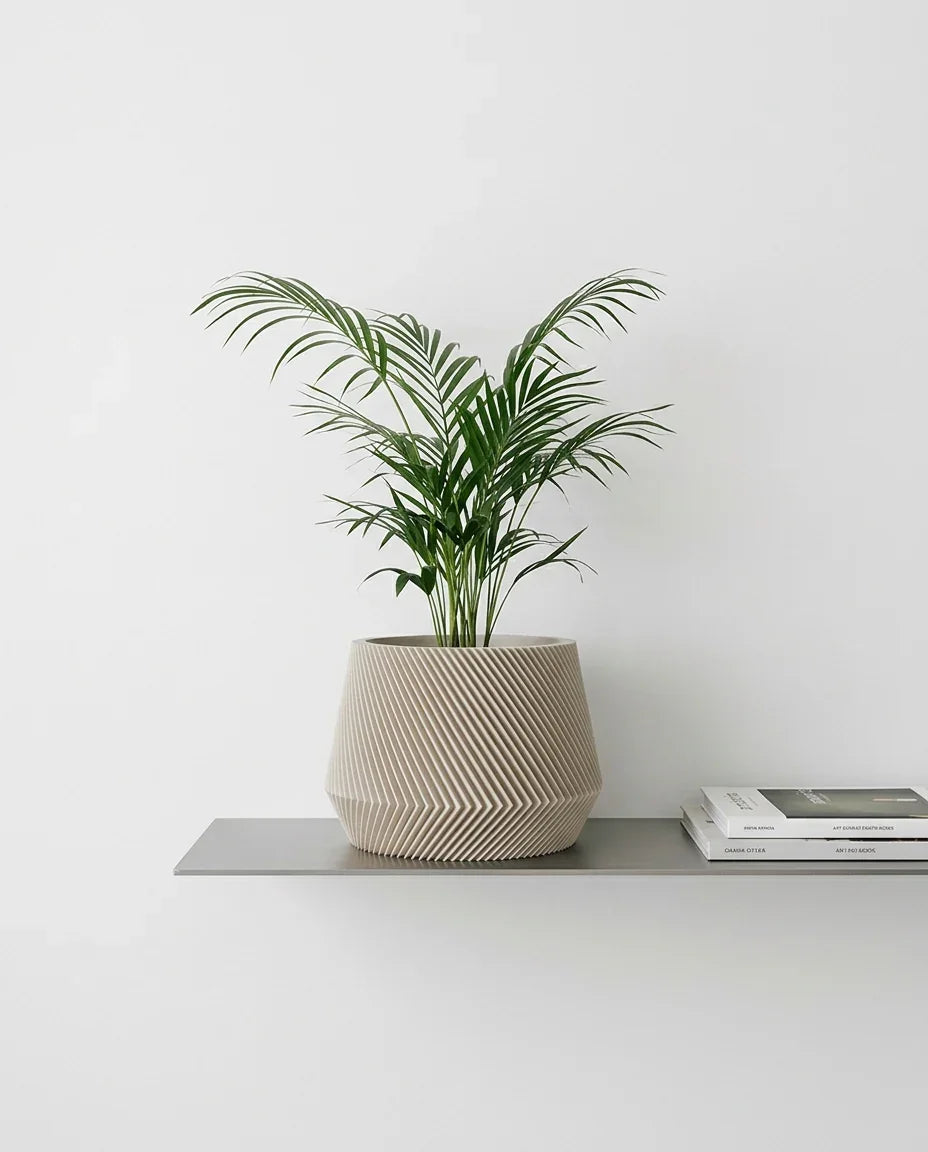 Oslo planter in mist white color, with acera palm plant on a steel shelf #color_Mist white