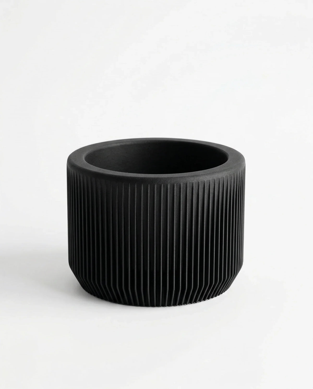 Black ribbed pot on a white background