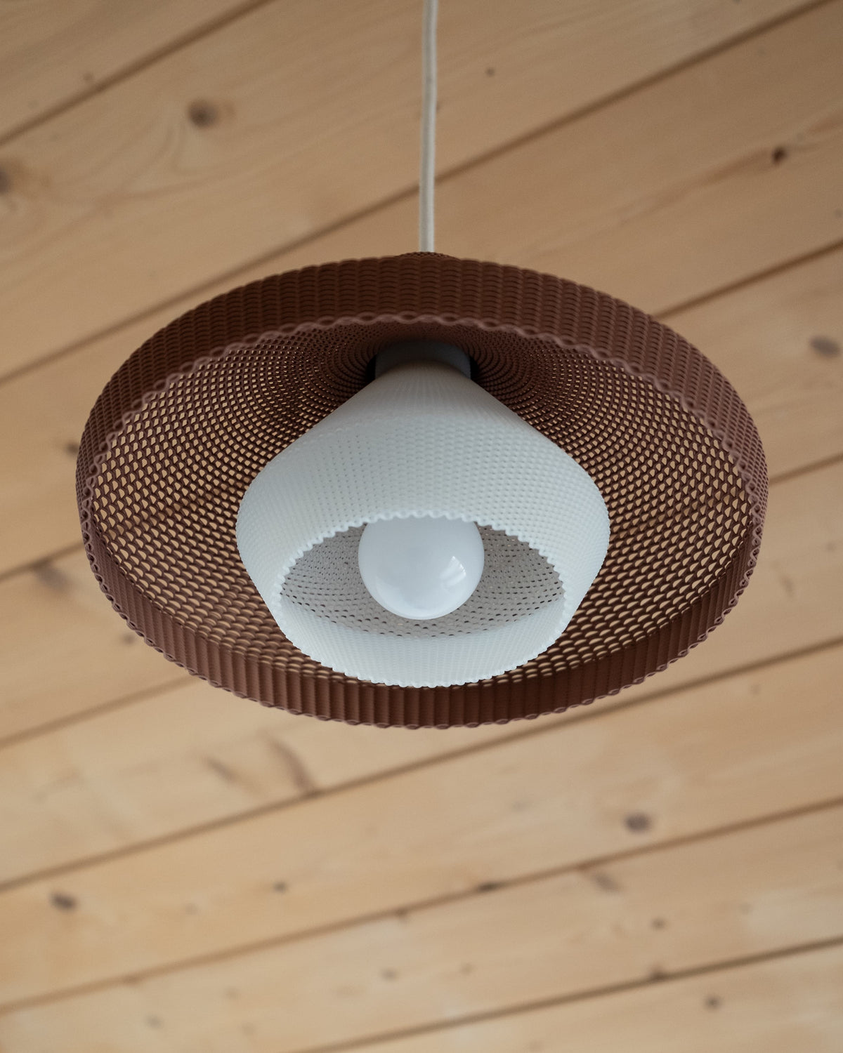 Minimum Design WOVE terracotta pendant, bottom view showing opaline diffuser and woven ribbed interior