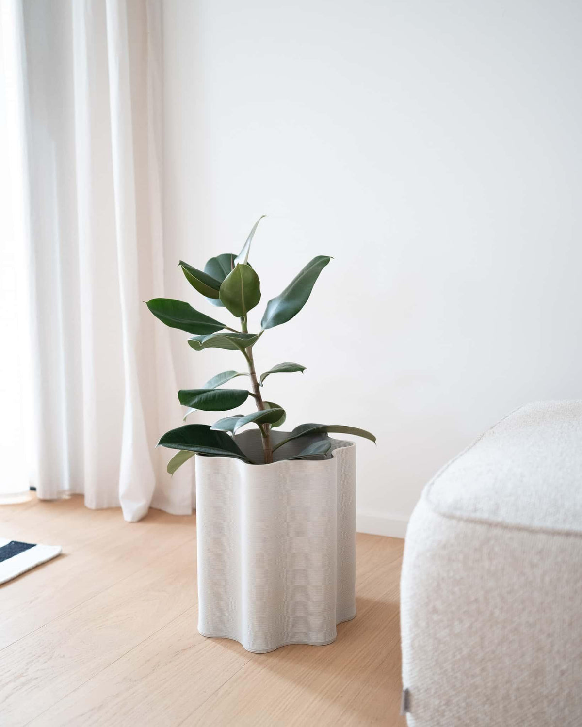 Top view of the Rippled floor planter in a minimalist setting, showing its wide 20cm opening and circular sculptural design.