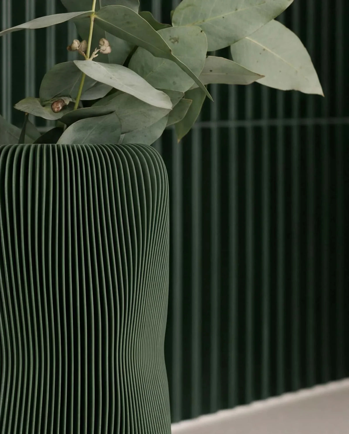 Soho sculptural vase forest green close-up wave texture detail - organic sculptural designer vase with eucalyptus