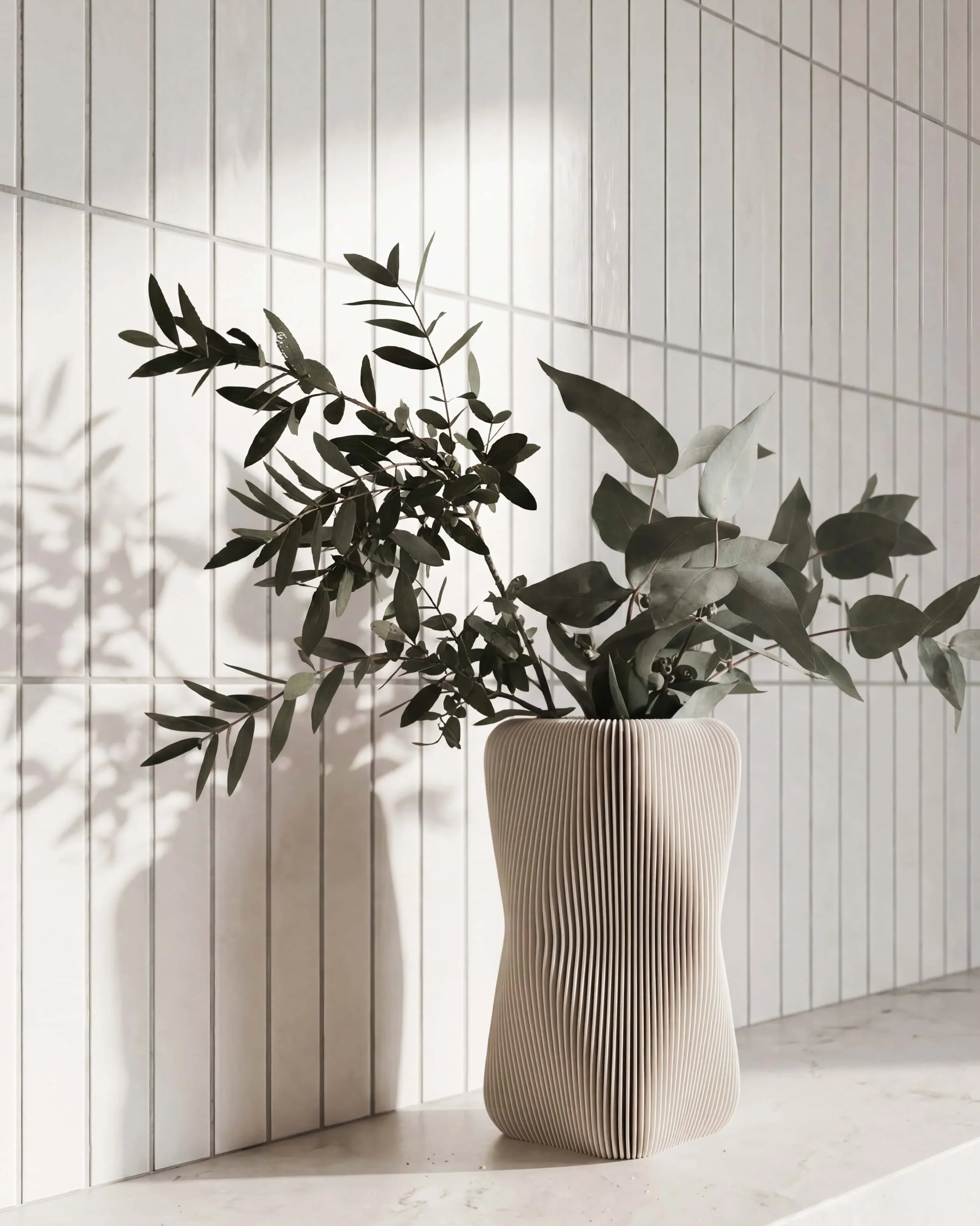 Soho sculptural vase mist white with eucalyptus branches - organic vase white tiled wall natural light