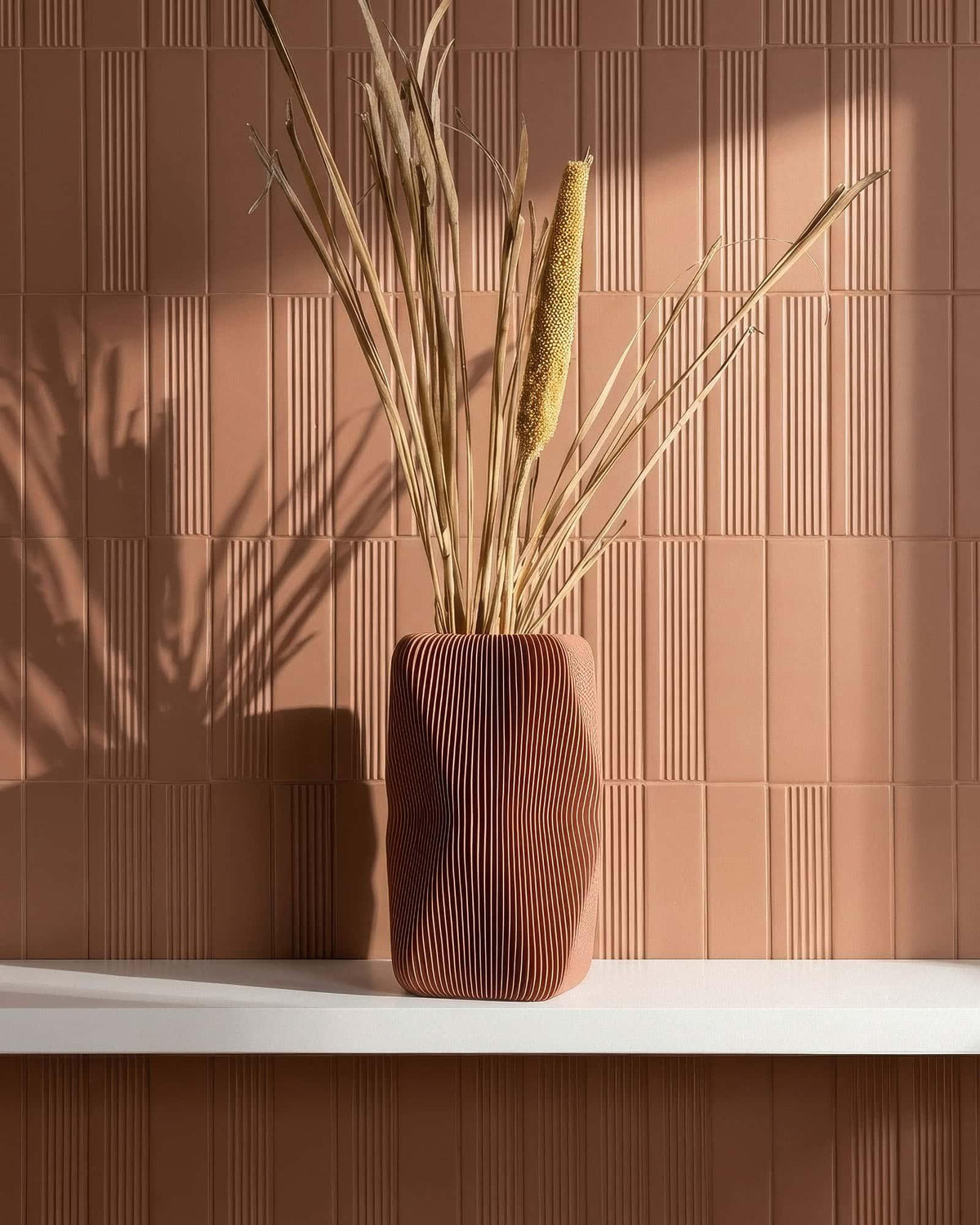 SOHO Terracotta vase with dried pampas on shelf, terracotta tiled wall, interior lifestyle