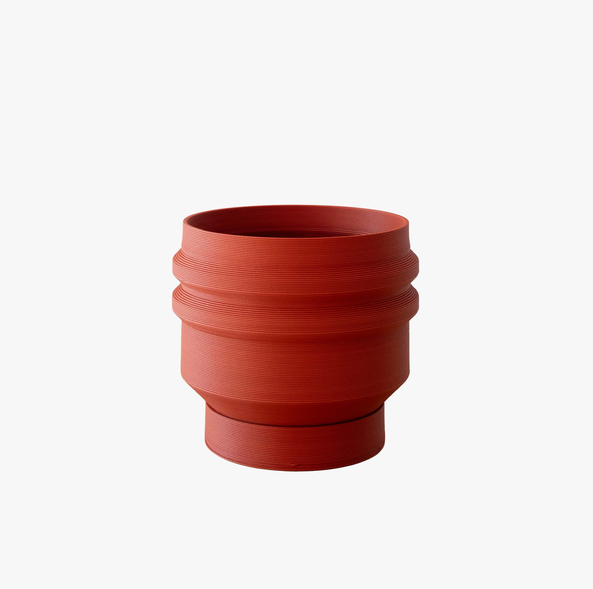 SYDNEY Wide architectural planter in Terracotta Rust, crafted from heavy wood composite, shown on a clean white background. Features a distinctive stratified texture and matching integrated saucer.