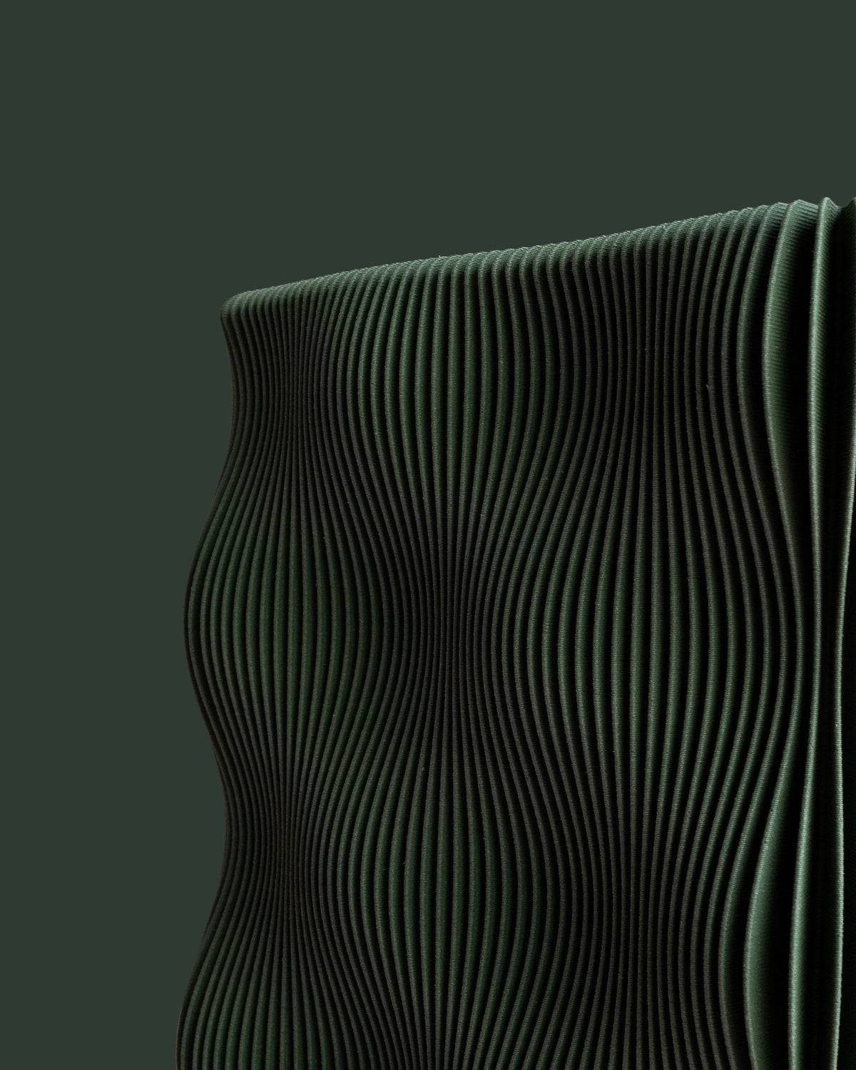 TIDE vase Green close-up wave-ribbed texture detail, matte forest green bio-sourced wood composite