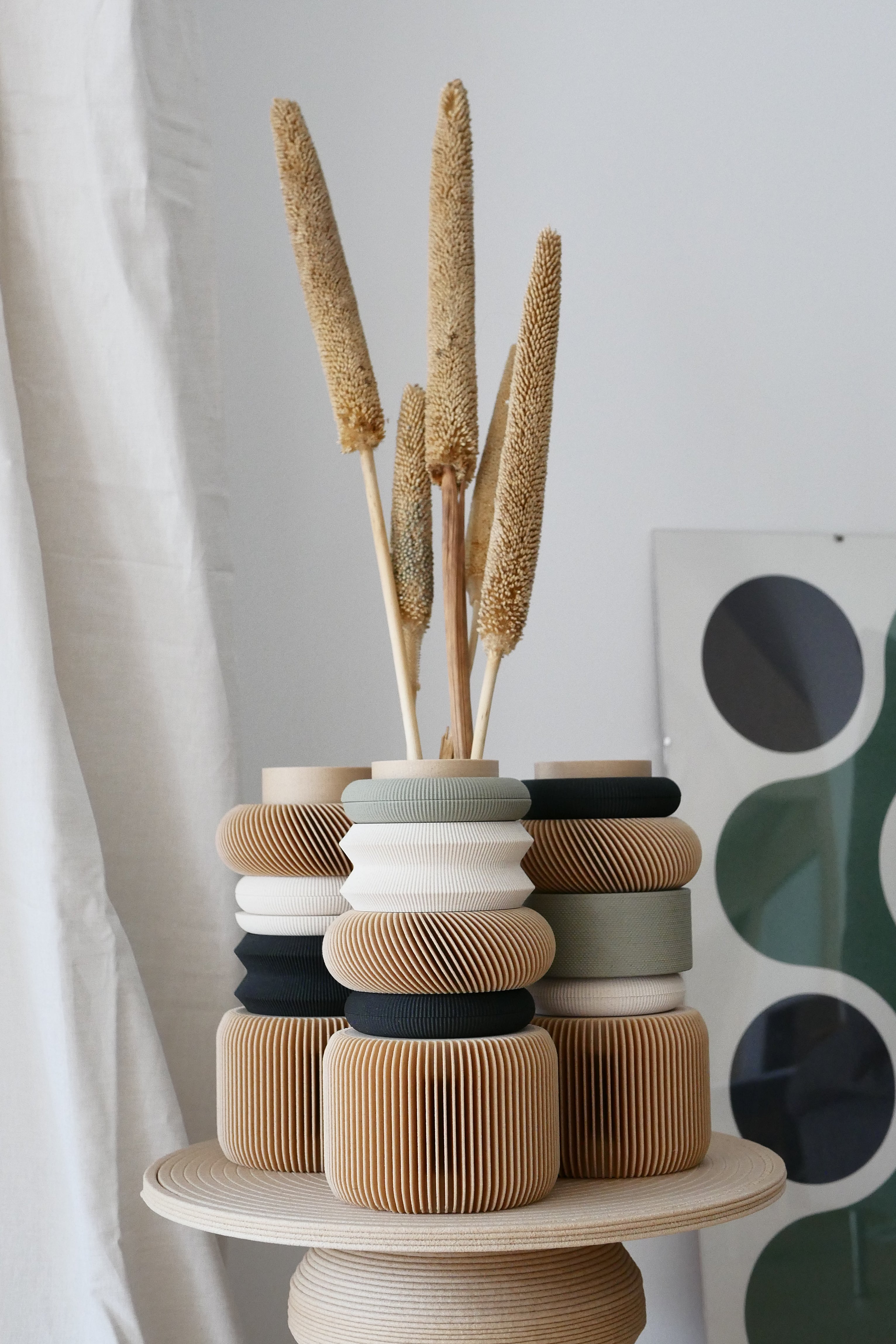 Decorative vase with dried reeds on a white background