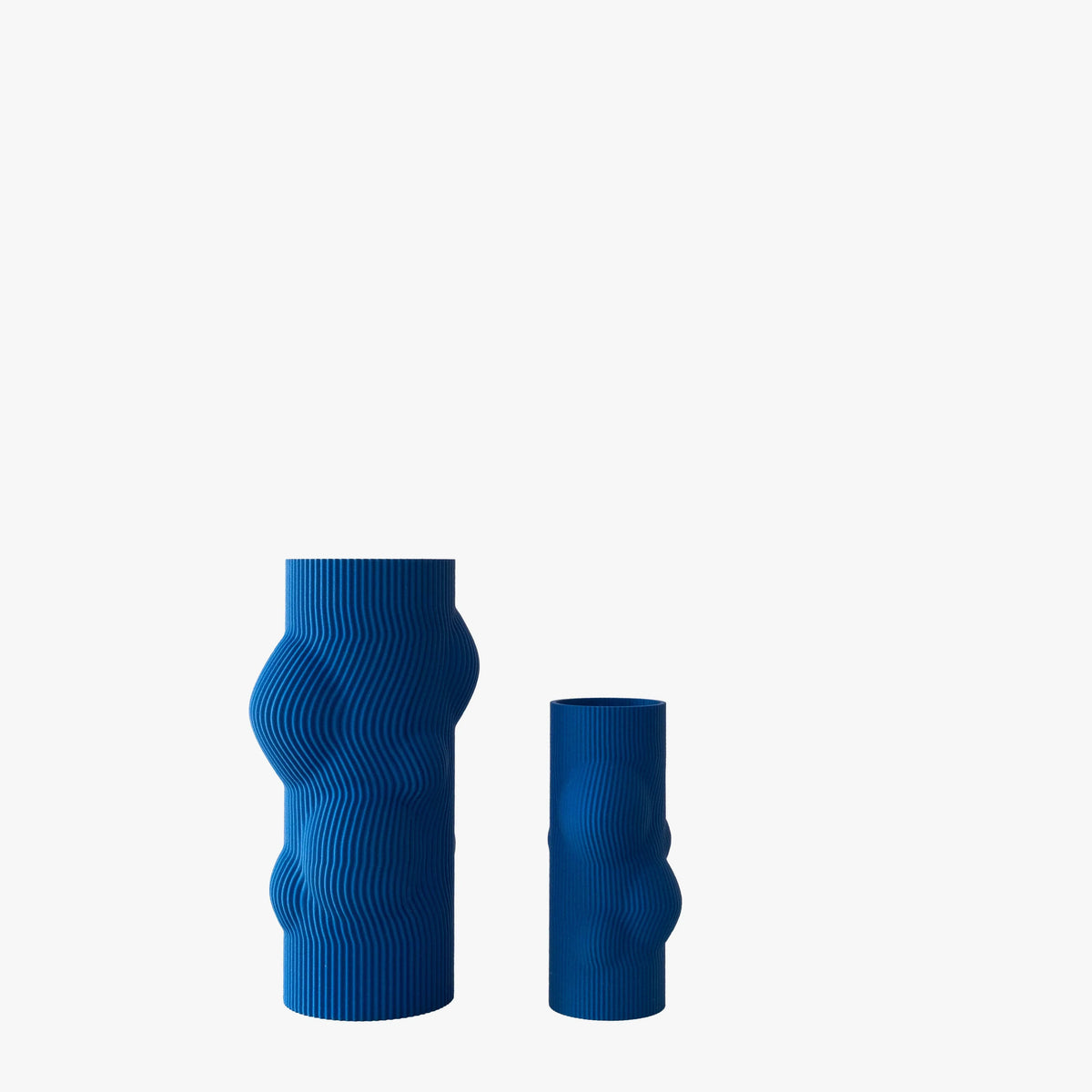 Two blue textured vases on a white background