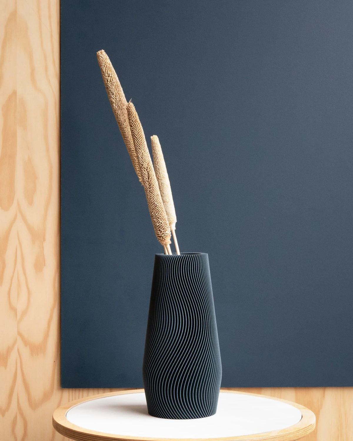 Wave vase petrol blue 25cm - textured organic design on a nordic shelf styling against a petrol blue wall